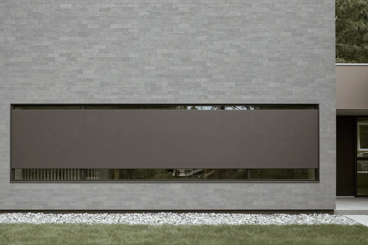 A slim aluminium-framed window on a modern rendered house