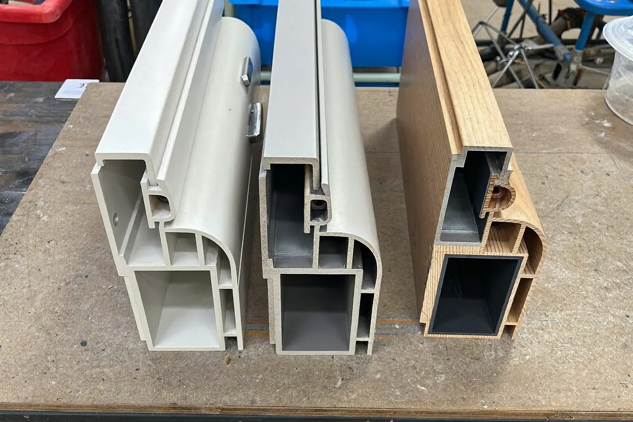 Samples of uPVC, aluminium and timber window frame profiles
